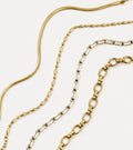 Signature Chain Bracelet Stack - flat lay of four layered gold bracelets